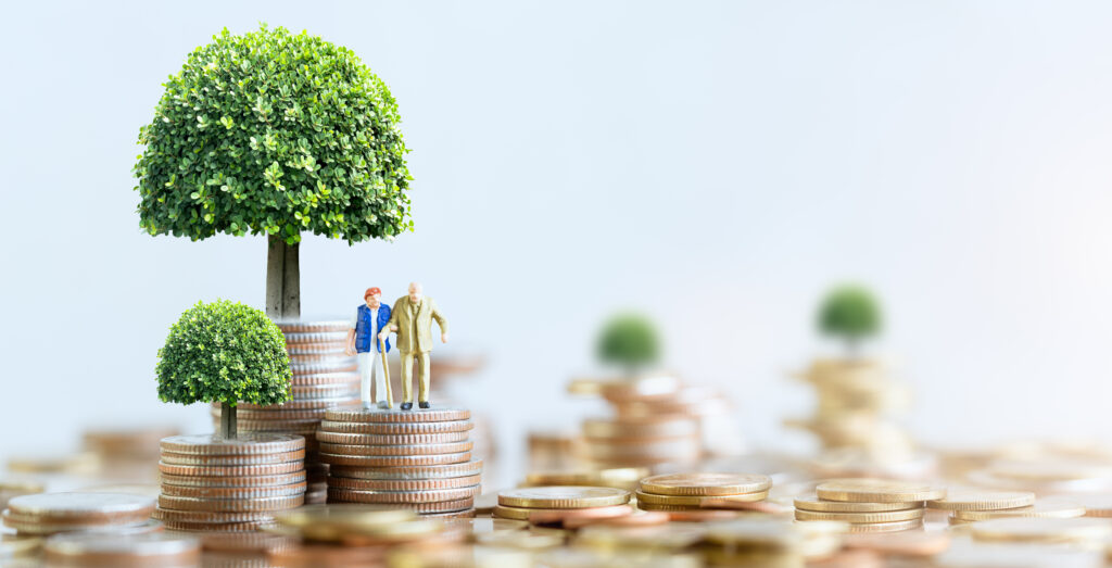 Miniature people: Elderly people sitting on coins stack. social